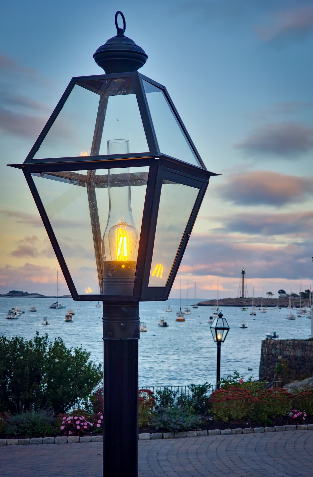Lantern post at sunset overlooking Marblehead Harbor with sailboats